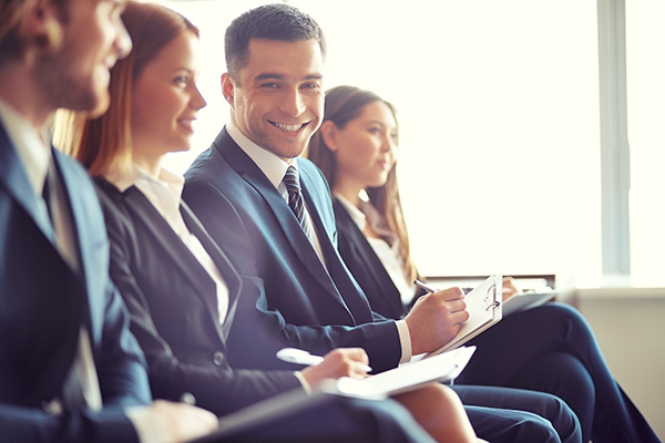 Smiling male real estate professional attending a class