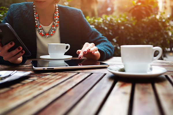 Well-dressed woman real estate agent meeting a client for coffee