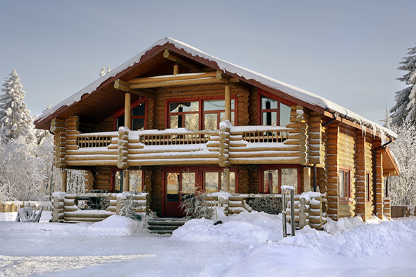 Beautiful log home dusted in winter snow